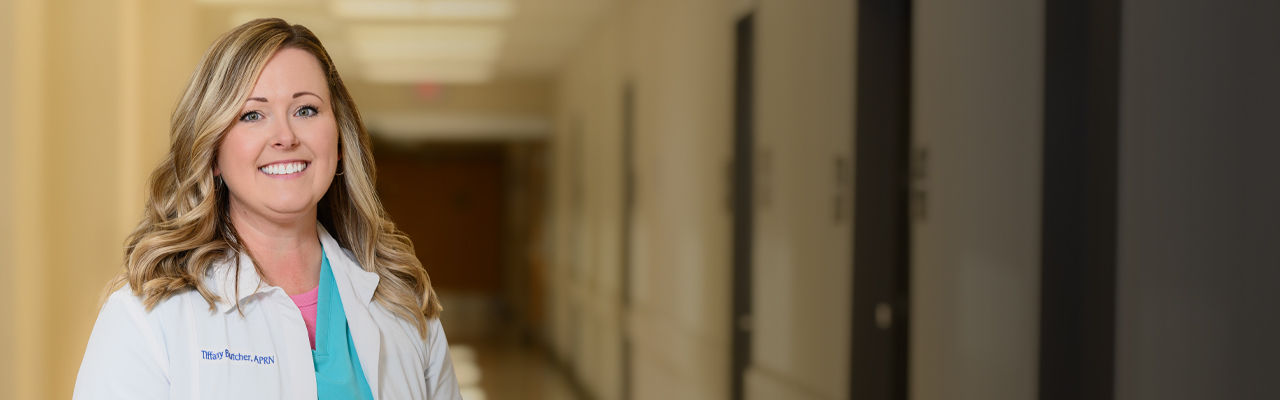 APRN standing in hallway smiling